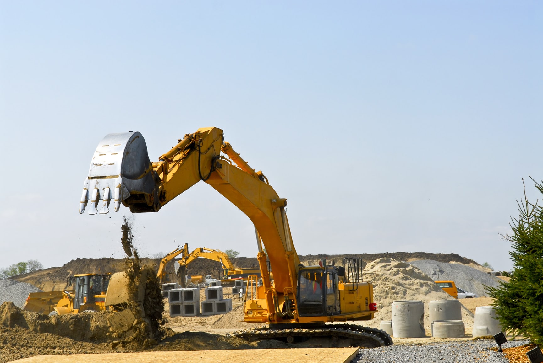 Yellow bulldozer machines digging